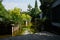 Waterside planked path in verdant city of sunny summer morning