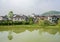 Waterside tile-roofed buildings in sunny spring morning