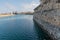 Waterside wall before the city buildings on the coastline under the blue sky in Peniche