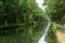 Waterways in Belgium, manmade canal with oak trees alley