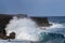 Wave on Black Sand Beach, Big Island, Hawaii. Volcanic Cliffs in background