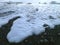 Wave Bubbles and Melting Icebergs on the Black Sand Beach