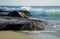 Wave crashing on rocks at Aliso Beach in Laguna Baech, California.