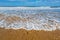 Wave flowing onto a sandy beach