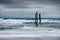 Wave hitting decay wooden bridge on the beach in stormy