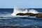 Wave hitting a rock in the ocean making a big splash