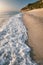 Wave at Milos beach at sunset near the Agios Nikitas village on Lefkada Ionian island, Greece. Evening golden light