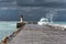 Wave over pier during storm, in Cape Town South Africa