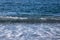 Wave on the pebble coast of sea. Selective focus