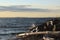 A Wave on the Rocky Shore at Sunset