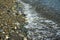 Wave running on a pebble beach