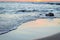 Wave of the sea on the sand beach. Seashore on sunset