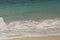 Wave of the sea swashing up onto sand beach, summer background