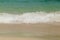 Wave of the sea swashing up onto sand beach, summer background