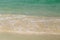 Wave of the sea swashing up onto sand beach, summer background