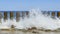 Wave on the seashore crashes on wooden breakwaters