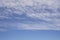 Wave of softy and white fluffy clouds under deep blue sky