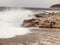 Wave splashing Croatian coastline and rough sea causing waves to crash on rocks
