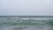 Wave spray splash over beach at blue sea. Soft wave on the sandy beach. Sea sunset