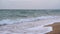 Wave spray splash over beach at blue sea. Soft wave on the sandy beach. Sea sunset