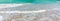 Wave surf on the sea coast, clean sea shore and turquoise water, horizontal panoramic image, background for banner