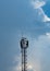 Wave transmission mast, large phone signal with a bright blue sky.
