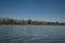 Waveless calm water surface with landscape view on the horizon