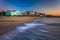 Waves in the Atlantic Ocean and beachfront homes at sunrise, Edisto Beach, South Carolina.