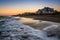 Waves in the Atlantic Ocean and beachfront homes at sunset, Edisto Beach, South Carolina.