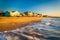 Waves in the Atlantic Ocean and morning light on beachfront home