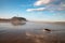 Waves, beach and lighthouse cliff