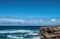 Waves are beating against rocky shore of sea on sunny summer day