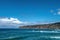 Waves are beating against rocky shore of sea on sunny summer day