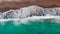 Waves beating on a sand beach. Aerial view.