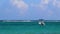 Waves boats caribbean coast and beach panorama view Tulum Mexico