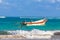 Waves boats pelicans caribbean coast and beach panorama Tulum Mexico