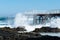 Waves breaking against pier on the beach