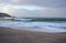 Waves breaking against Riazor Beach with sunset light. Wild sea with foam. La Coruna, Spain, autumn storm.