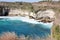 Waves breaking at bottom of steep cliffs, Nusa Penida, Indonesia