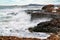 Waves breaking coastal rocks
