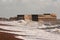 Waves breaking over rock & concrete breakwater