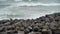 Waves breaking over rocks on the beach.