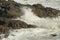 Waves breaking over rocks near Mumbles, Wales, UK