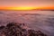 Waves breaking over rocks at sunset in Langebaan lagoon, South Africa