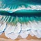 Waves chrashing on a tropical beach seen from a drone view