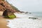 Waves at the cliff of Varkala along the coast with volcanic stones, India