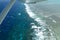 Waves and colourful coral formations on the Great Barrier Reef in Queensland, Australia