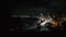 Waves crash along the beach in a wide shot of Tel-Aviv at Night