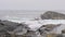 Waves Crash Along Shoreline in Maine USA on Overcast Day