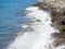 Waves crash on big rocks. Rocky coast and wave. Powerful coastline. Sea foam. The excitement of the sea. Huge coastal rocks